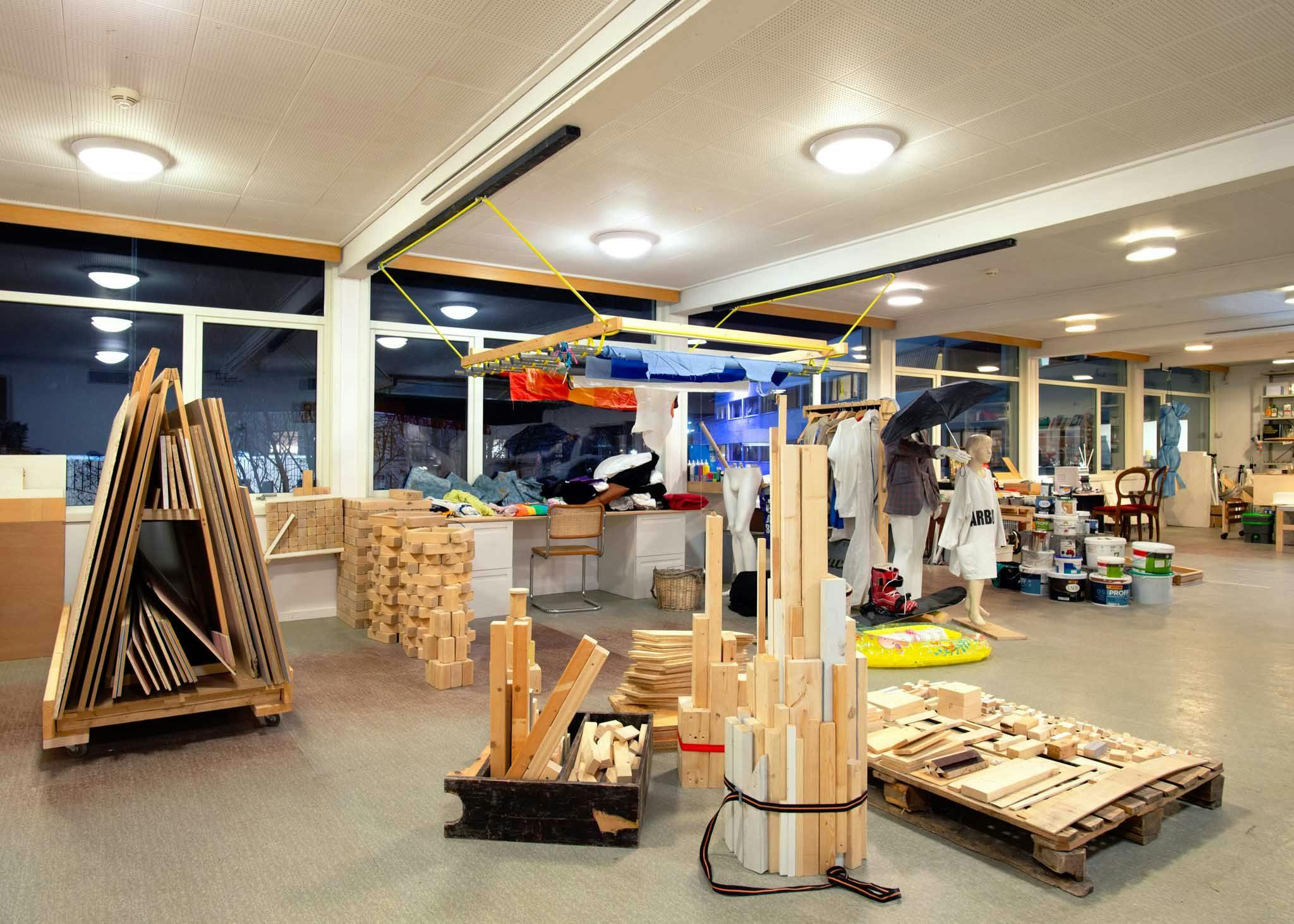 Various wooden items are organised by form and size in a large room.